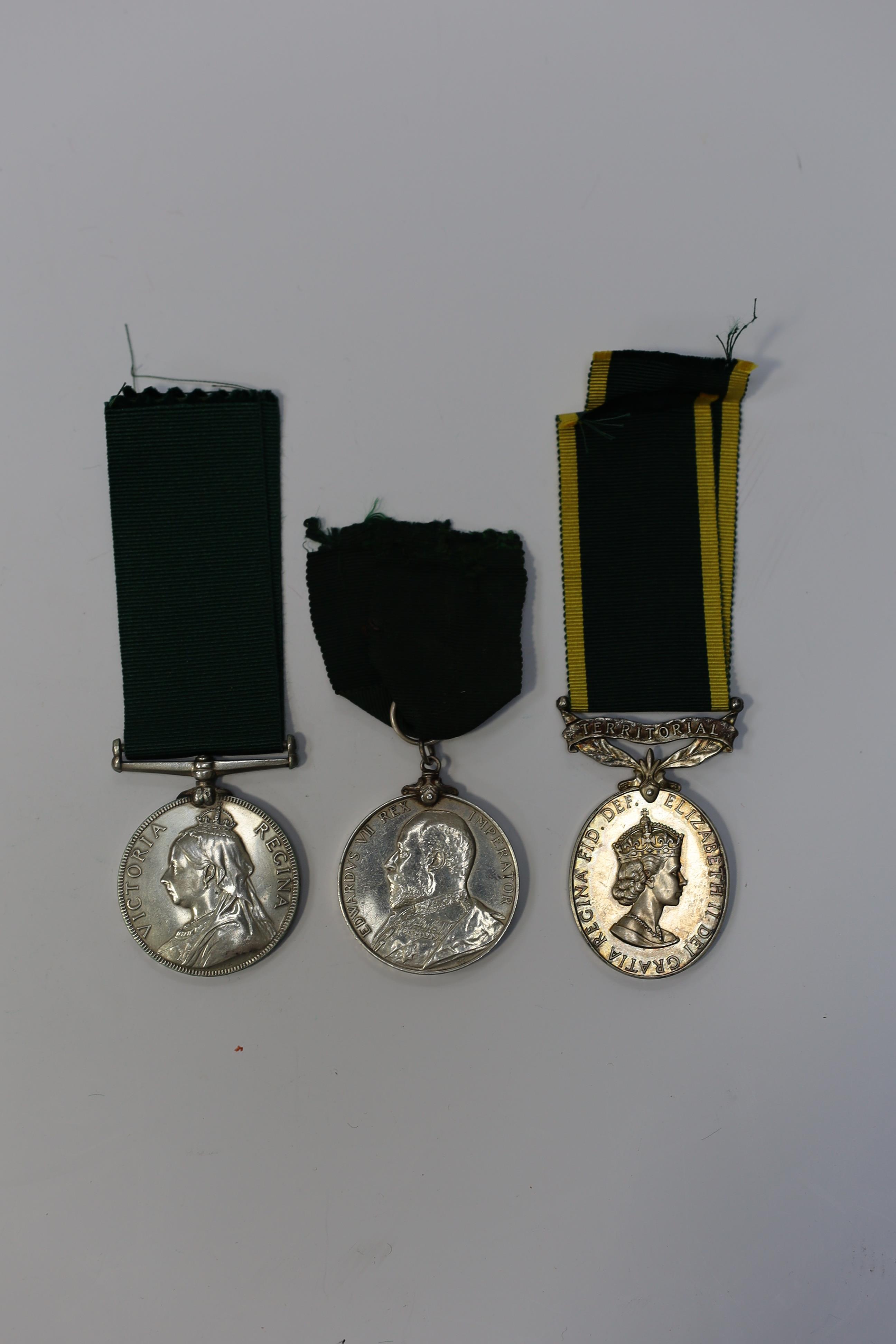 Three assorted service medals; Vict Volunteer Long Service to 186. Cpl. J.Camplin. 1st Dorset.Vol.Art: Ed VII Volunteer Long Service to 2731 Sjt:A.G.Wright. 4/V.B.Durham L.I.; ERII Territorial Efficiency Medal to 2228226